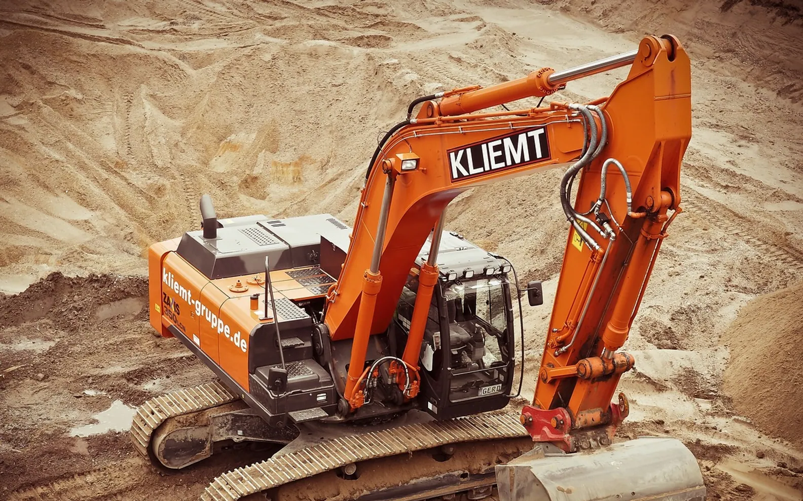 Excavator, construction and site